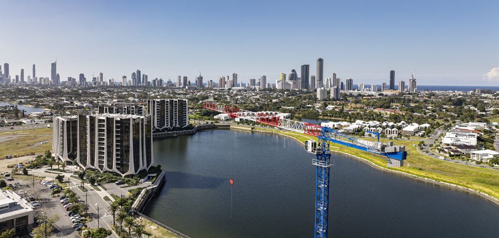 Tower crane on a riverside site at Mermaid Waters, Gold Coast skyline beyond