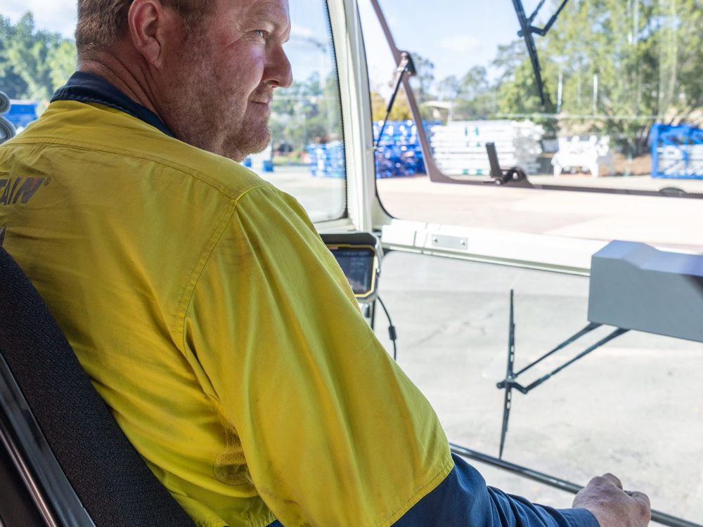 A TES technician in the cab of a crane on site