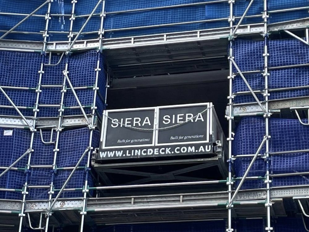 SIERA project loading bay with Linc Deck signage, on a scaffolded high-rise